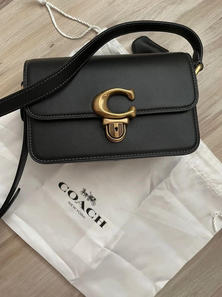 Elegant Black Structured Shoulder Bag with Gold-Tone C Clasp
