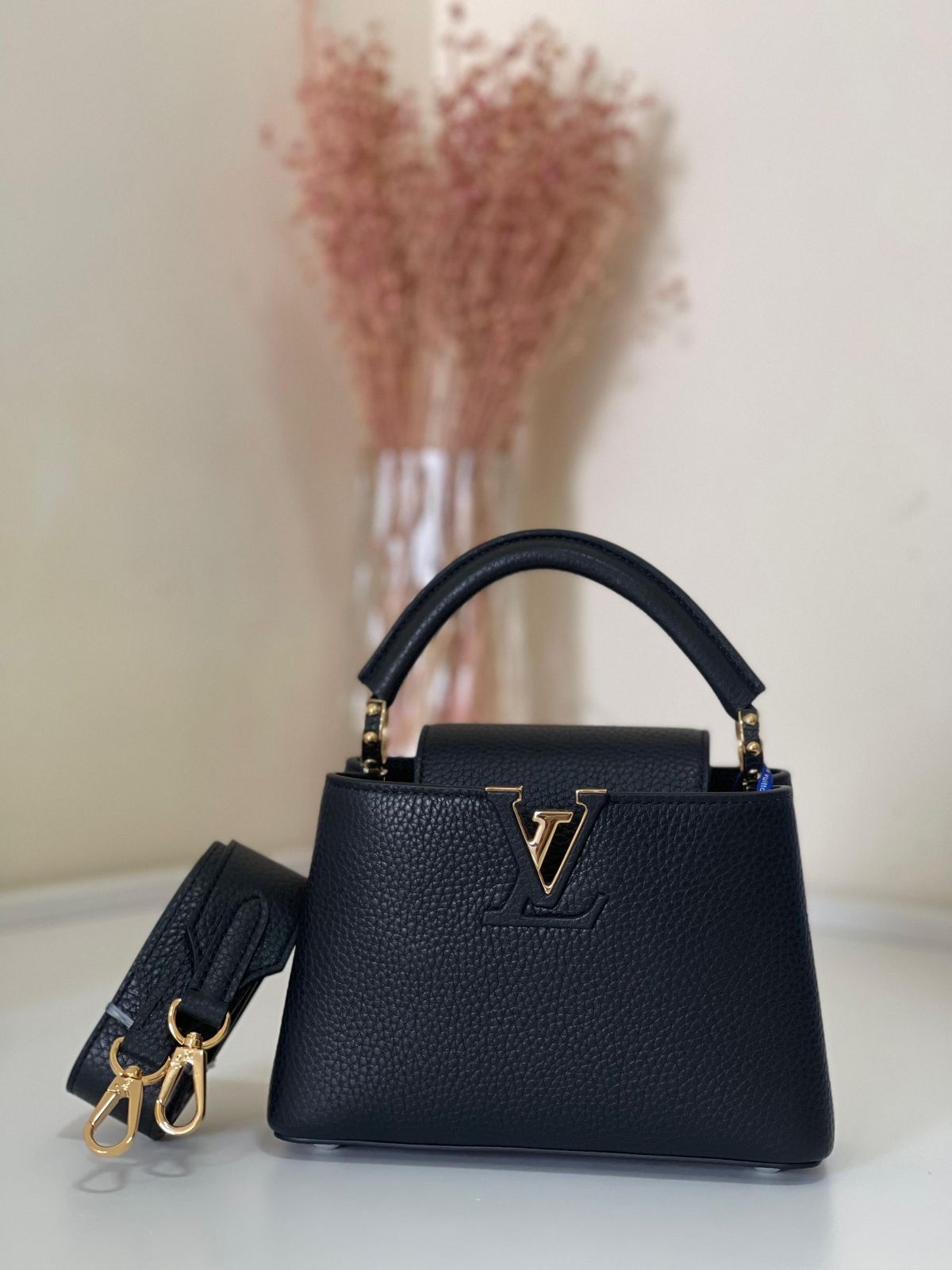 Elegant Black Structured Top-Handle Handbag with Gold V-Clasp