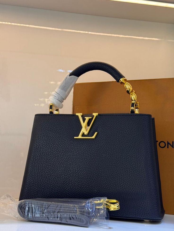 Elegant Black Structured Top-Handle Handbag with Gold V-Clasp