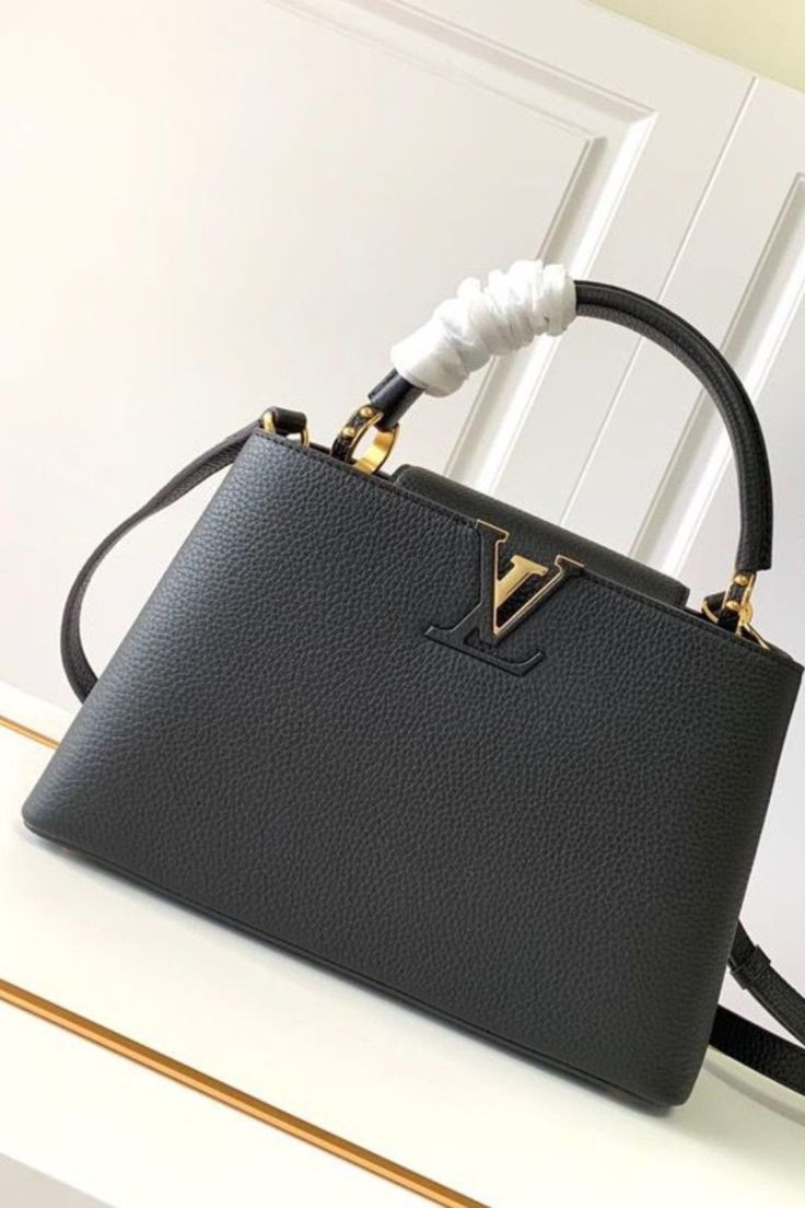 Elegant Black Structured Top-Handle Handbag with Gold V-Clasp