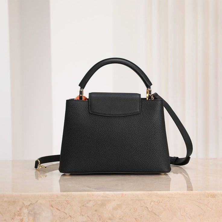 Elegant Black Structured Top-Handle Handbag with Gold V-Clasp