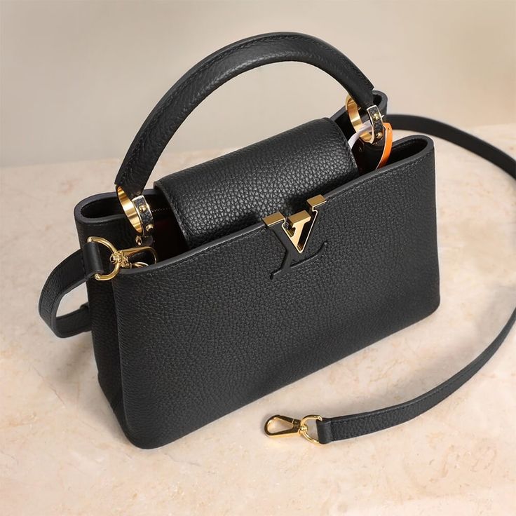 Elegant Black Structured Top-Handle Handbag with Gold V-Clasp
