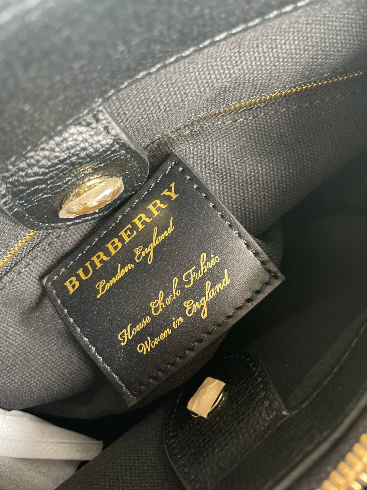 Elegant Black Structured Handbag with Brown Leather-Style Handles